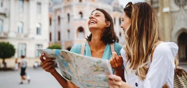 couple holding a map for directions and laughing