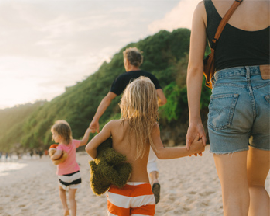 family walking on a beach