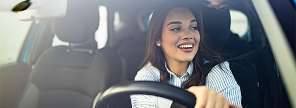 woman smiling driving her car